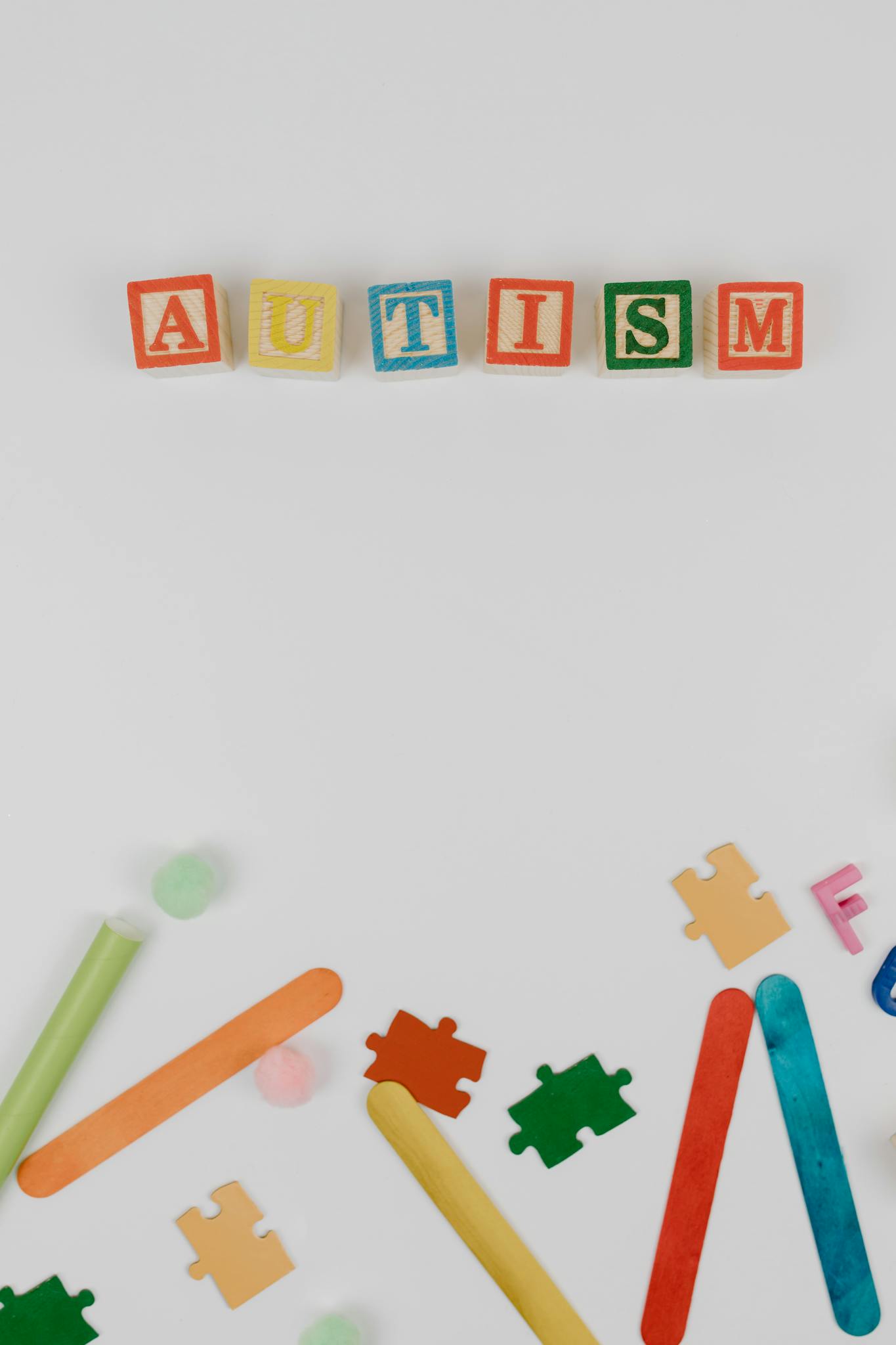 Colorful autism awareness display with blocks and educational materials